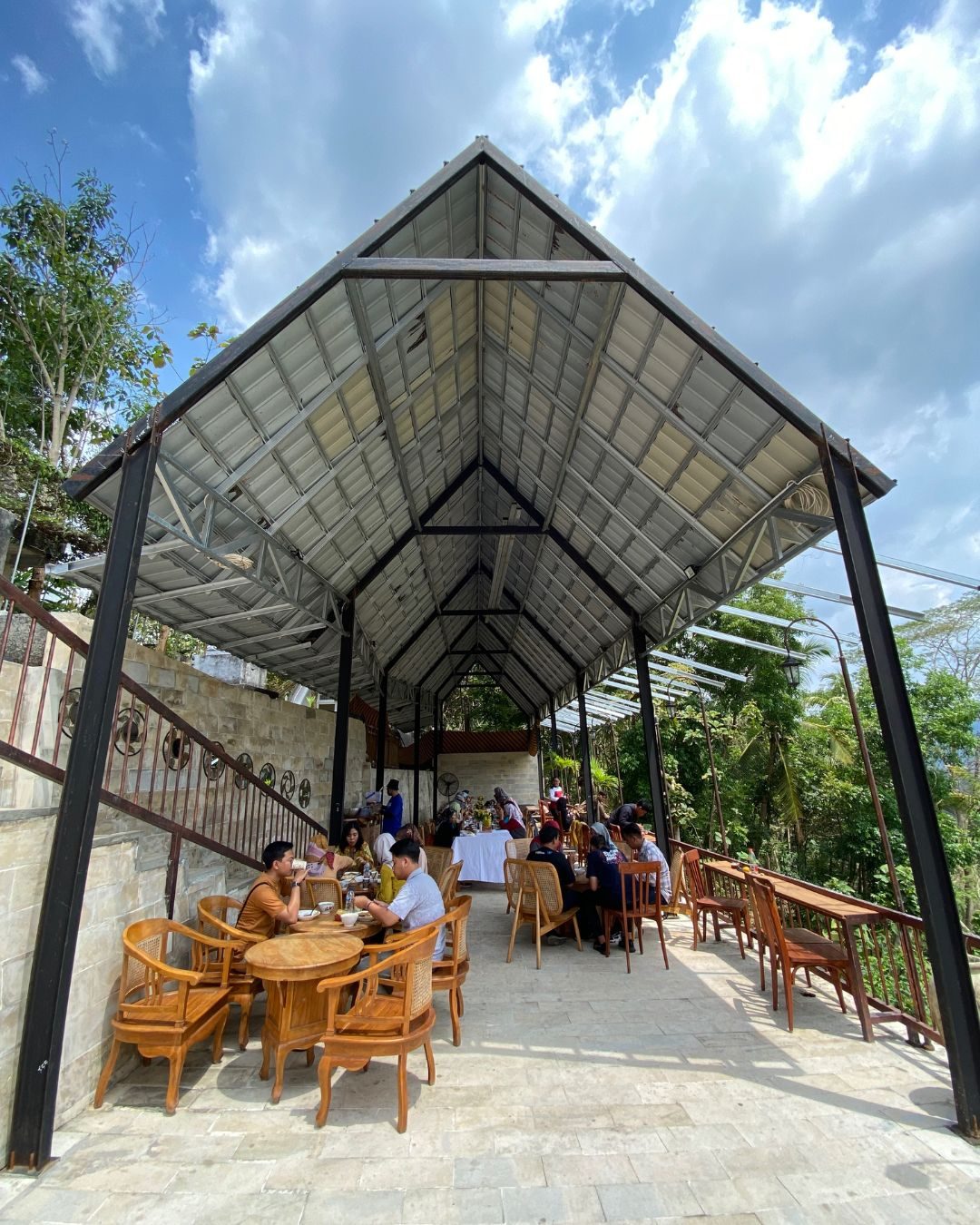 Guests dining under a covered outdoor pavilion at Kedai Bukit Rhema, a restaurant near Borobudur